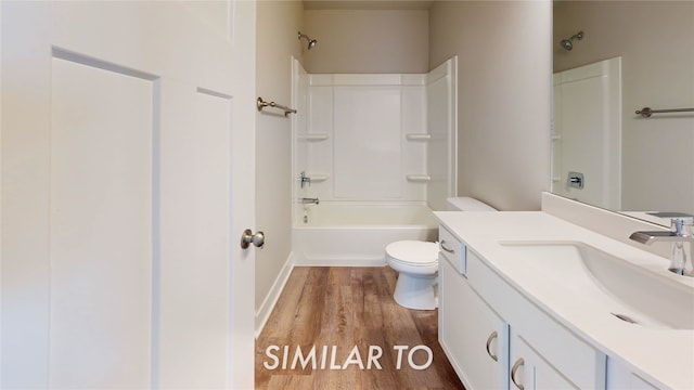 full bathroom featuring wood-type flooring, toilet, tub / shower combination, and vanity