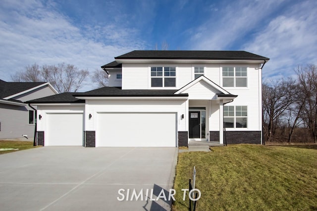 view of front of property featuring a garage and a front lawn