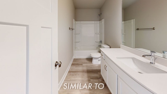 full bathroom with washtub / shower combination, wood-type flooring, toilet, and vanity