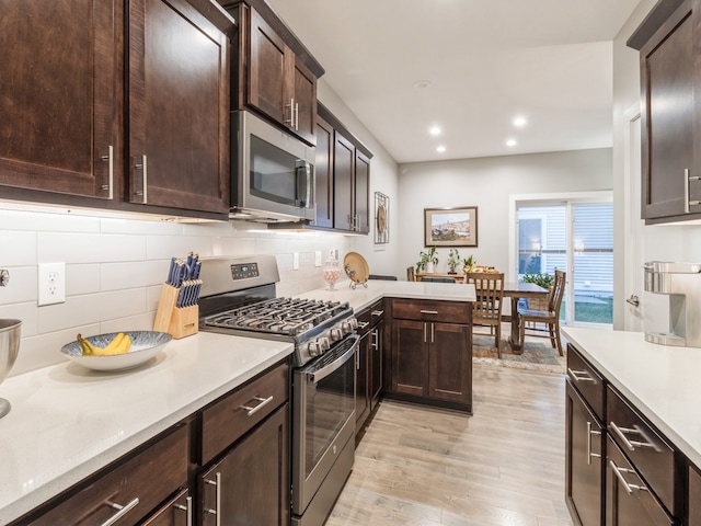 kitchen featuring backsplash, light hardwood / wood-style floors, dark brown cabinetry, and stainless steel appliances