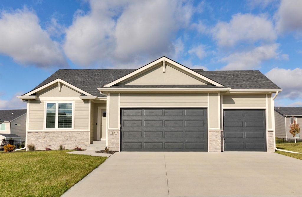 view of front of property with a garage and a front yard