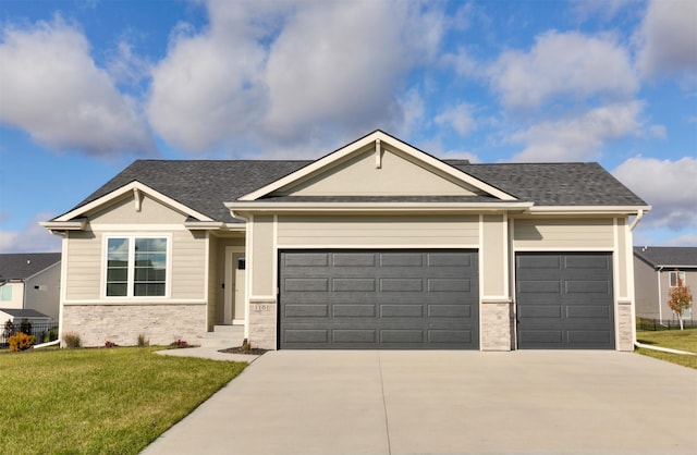 view of front of property with a garage and a front yard