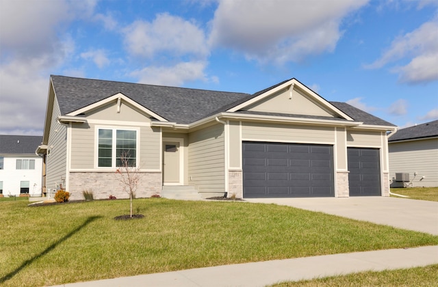 view of front facade with cooling unit, a garage, and a front lawn