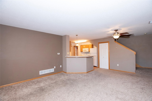 unfurnished living room with ceiling fan and light colored carpet