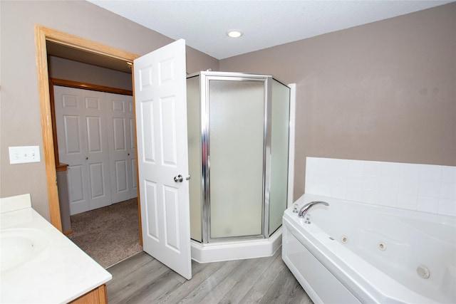 bathroom featuring vanity, wood-type flooring, and independent shower and bath