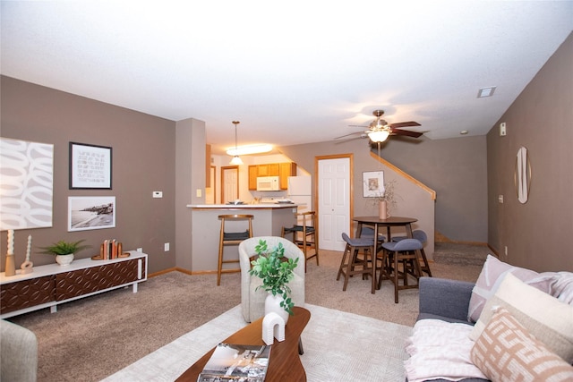 living room with ceiling fan and light carpet