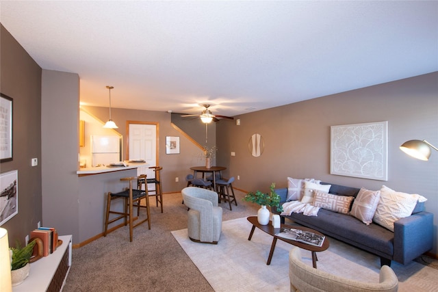 living room with light carpet and ceiling fan