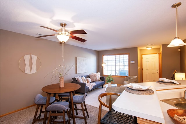 carpeted dining space featuring ceiling fan