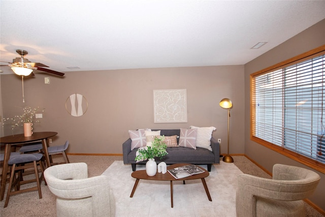 living room featuring ceiling fan and light colored carpet