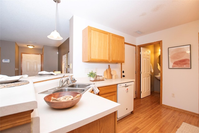 kitchen with pendant lighting, dishwasher, light brown cabinets, light hardwood / wood-style floors, and kitchen peninsula