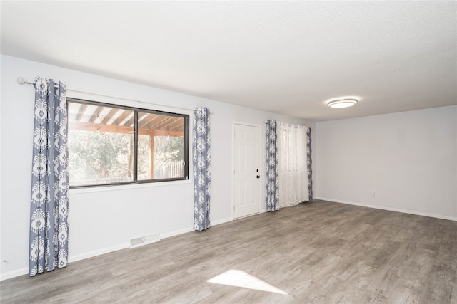 unfurnished room with light hardwood / wood-style flooring