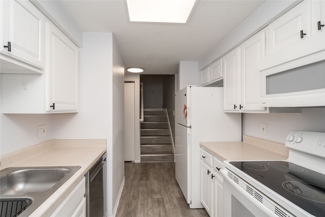 kitchen with hardwood / wood-style floors, white appliances, and white cabinetry