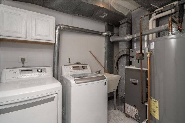 laundry area with separate washer and dryer, sink, cabinets, and gas water heater