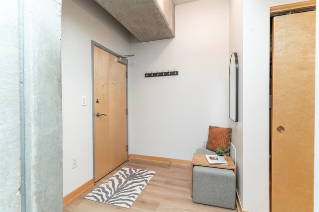 corridor with light hardwood / wood-style flooring