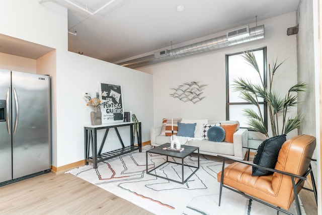 living room with light hardwood / wood-style flooring