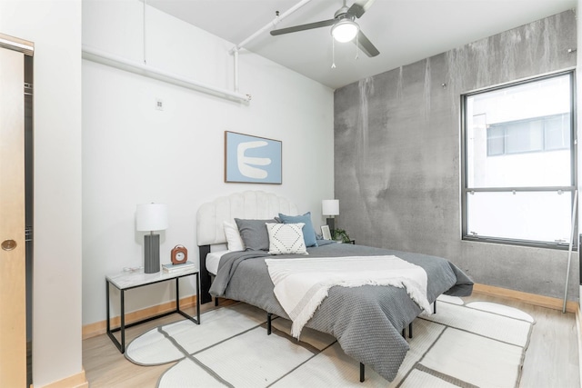 bedroom featuring light hardwood / wood-style flooring and ceiling fan