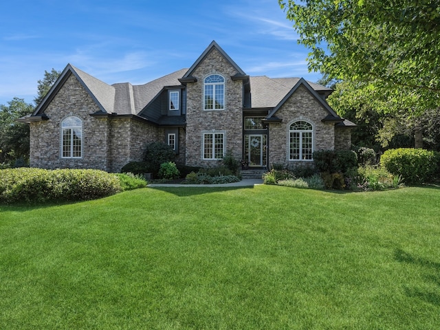 french country home with a front lawn