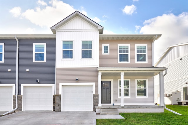 view of property featuring a garage and a front yard