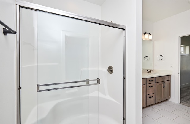 bathroom with tile patterned floors, vanity, and walk in shower