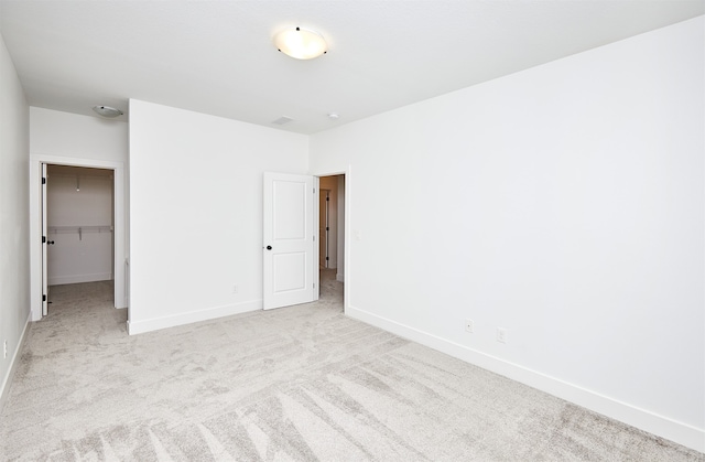 spare room featuring light colored carpet