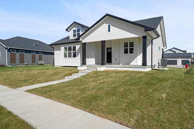 view of front of home with central AC unit, a porch, and a front lawn