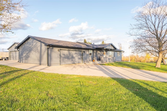 back of house with a garage and a lawn