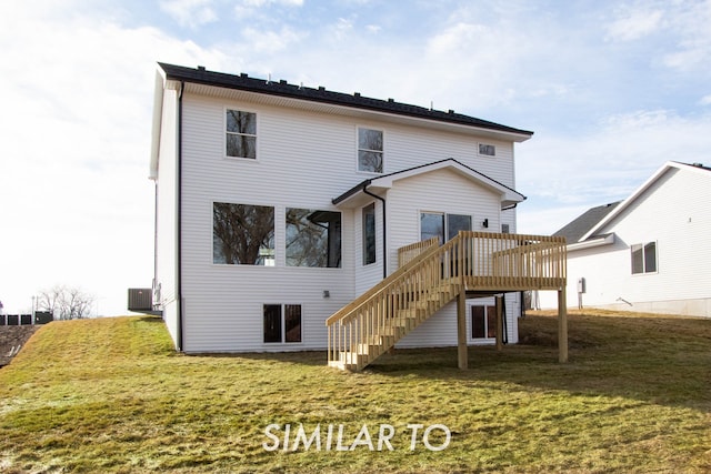 back of property with a yard, cooling unit, and a wooden deck