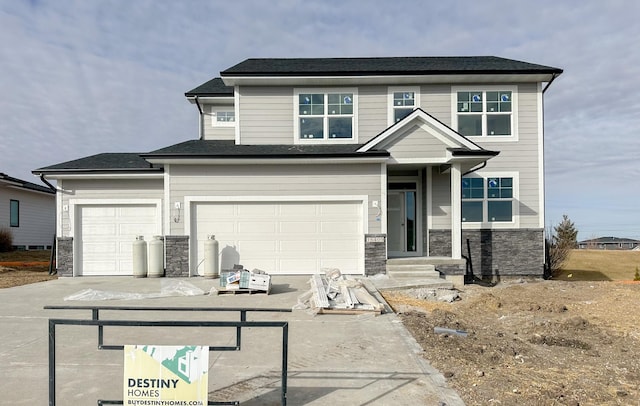 view of front of home featuring driveway and stone siding