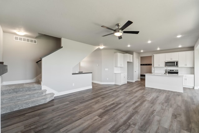 16409 Deerview Dr, Urbandale, IA 50323 - unfurnished living room featuring baseboards, a ceiling fan, dark wood-style floors, and visible vents