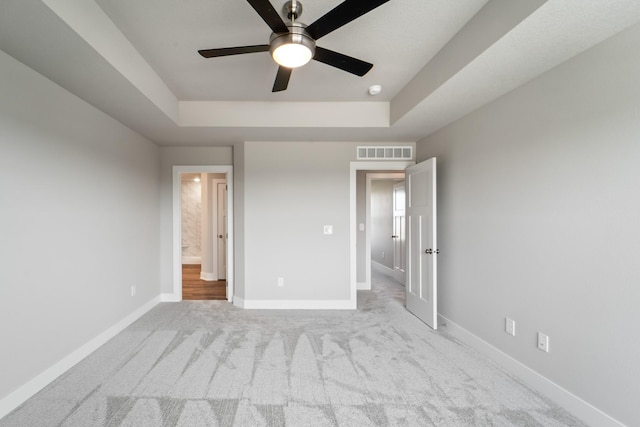16409 Deerview Dr, Urbandale, IA 50323 - unfurnished bedroom with visible vents, carpet, baseboards, and a tray ceiling