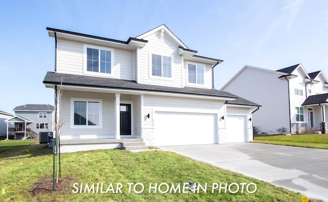 view of front of house with a front lawn, a garage, and central AC unit