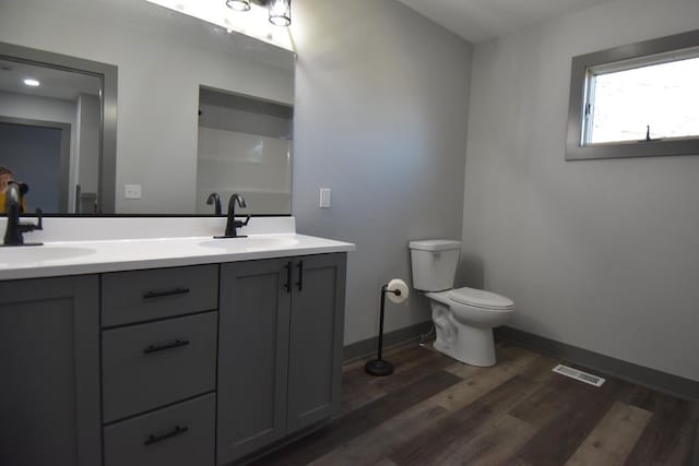 bathroom with vanity, hardwood / wood-style flooring, and toilet