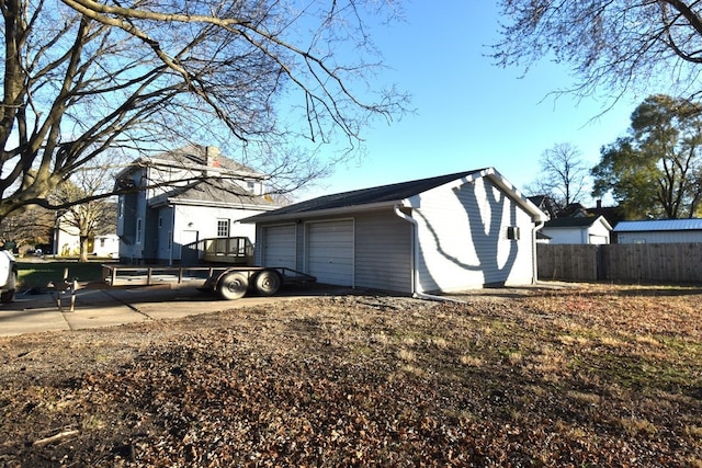 view of home's exterior featuring a garage and an outbuilding