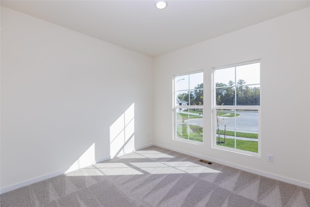 unfurnished room featuring light colored carpet