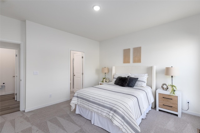 carpeted bedroom with ensuite bath