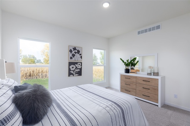 bedroom featuring light carpet