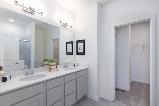 bathroom with toilet, an enclosed shower, and vanity