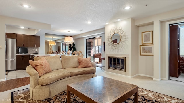 carpeted living room featuring a textured ceiling