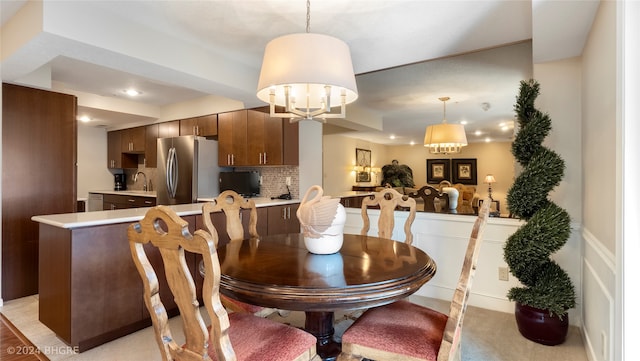 dining room featuring sink and a chandelier