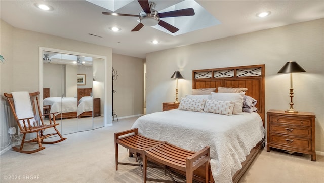 carpeted bedroom with ceiling fan and a closet