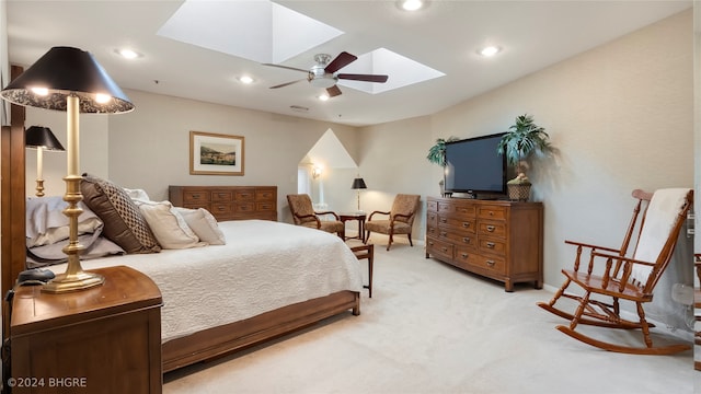 carpeted bedroom featuring a skylight and ceiling fan