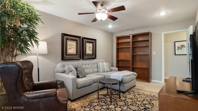 carpeted living room featuring ceiling fan