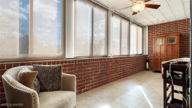 sunroom featuring ceiling fan