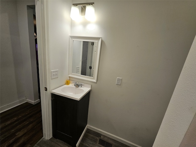 bathroom with vanity and wood-type flooring