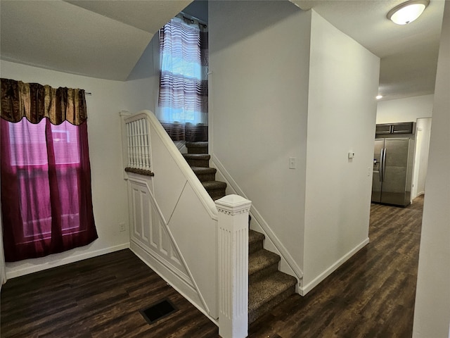 stairs featuring hardwood / wood-style flooring