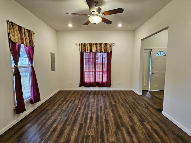 spare room with ceiling fan, dark hardwood / wood-style flooring, and electric panel