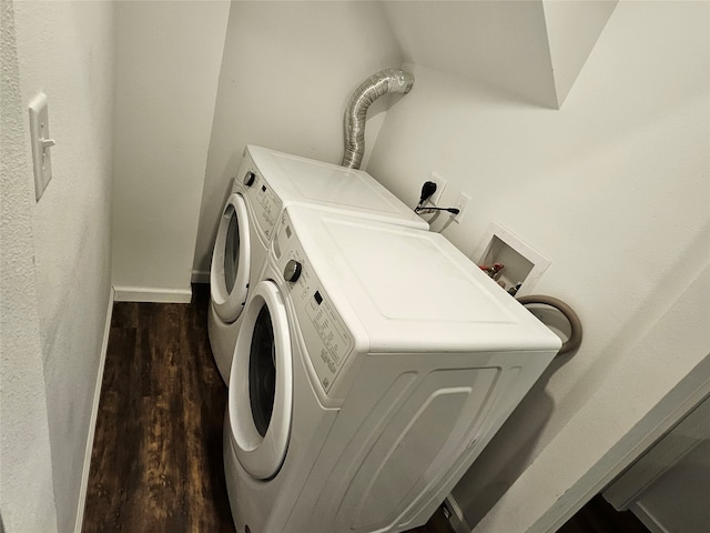 washroom featuring dark hardwood / wood-style floors and washing machine and clothes dryer