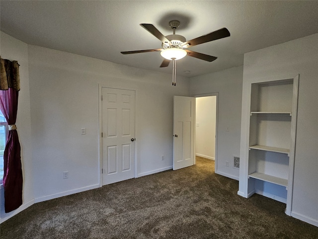 unfurnished bedroom with dark colored carpet and ceiling fan