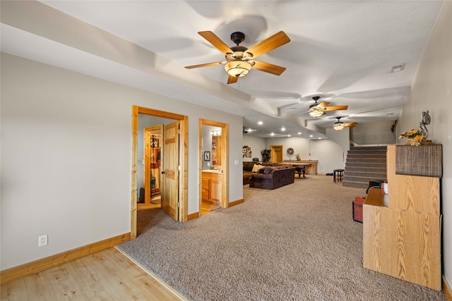 living room featuring wood-type flooring and ceiling fan