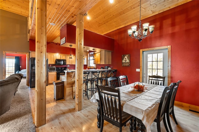 dining area featuring light wood-type flooring, wooden ceiling, high vaulted ceiling, and an inviting chandelier